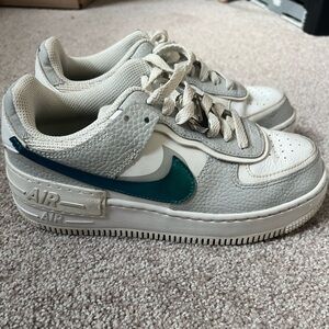 Nike White and Gray Sneakers with Teal Swoosh